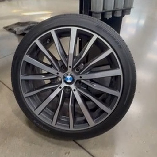 Low-profile tire mounted on a multi-spoke alloy wheel on the shop floor at Total Auto Works
