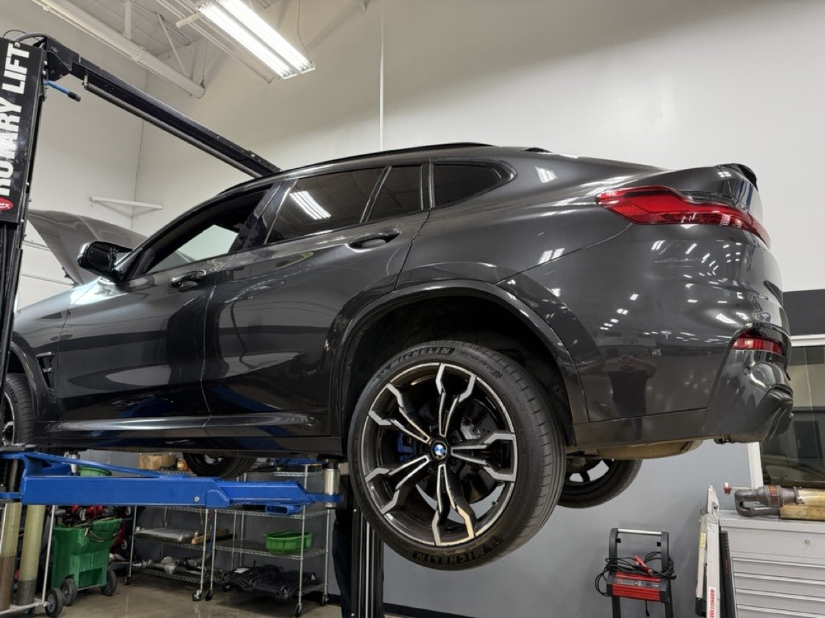 Vehicle lifted for service at Total Auto Works