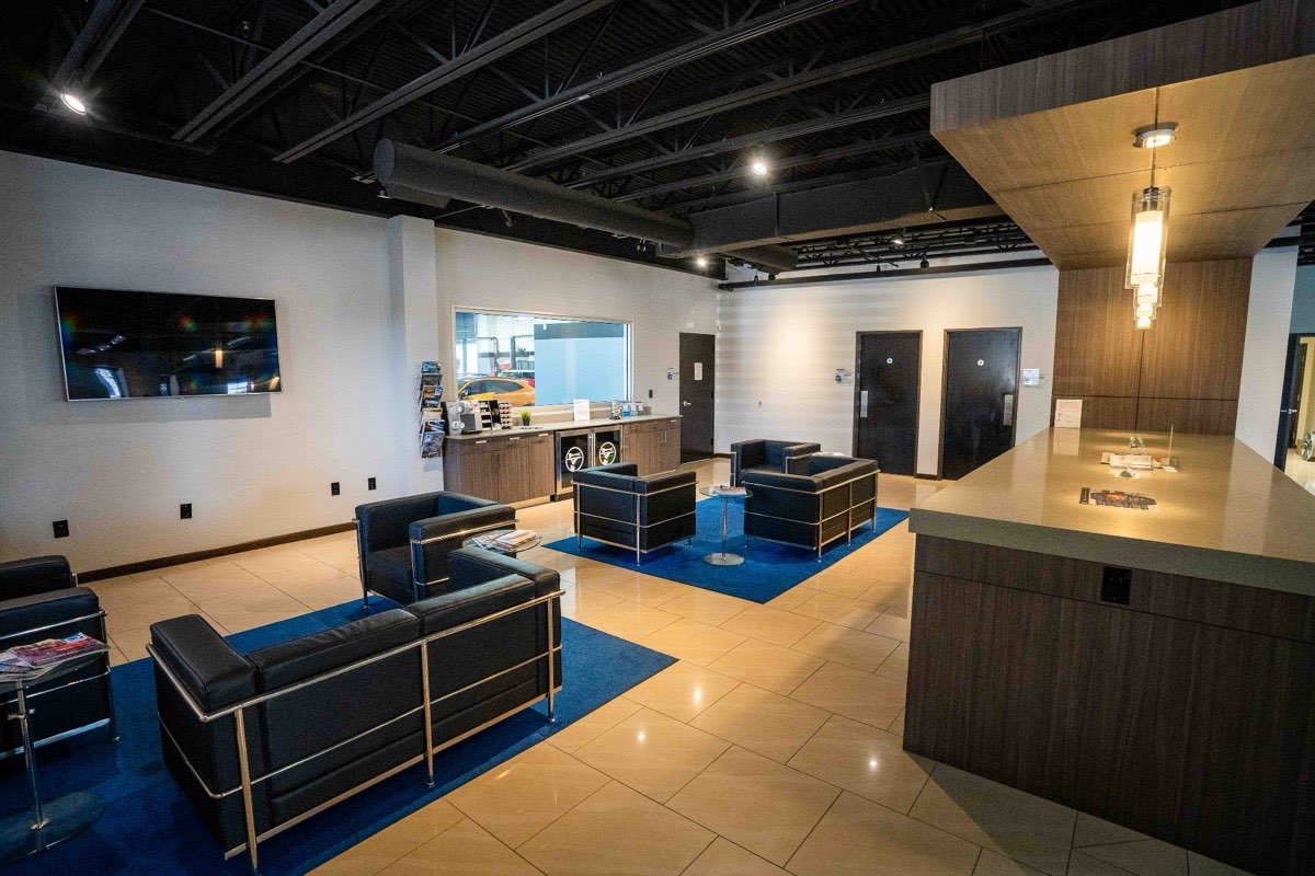 Total Auto Works customer waiting lounge with modern leather seating and front desk